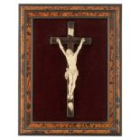 A richly sculpted ivory Baroque Corpus Christi on an ebonised crucifix, with the Memento Mori and th