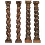 Two pair of richly carved oak and walnut Solomonic columns with a Corinthian capital, decorated with