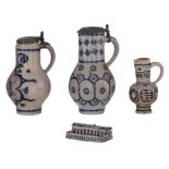 A collection of stoneware Westerwald items, consisting of an ink well, a small jug and two larger ju