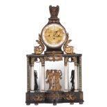 An ebonised wooden automaton Empire mantle clock, decorated with brass mounts, depicting to the fron