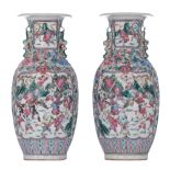 A pair of Chinese Canton famille rose vases, decorated with a battle scene, paired with Fu-lion hand