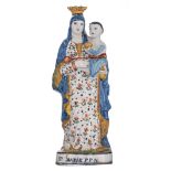 A polychrome decorated French pottery figure of the standing Madonna holding the Holy Child, with in