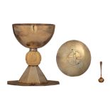 A silver 'martel‚-decorated' modernist chalice set in the middle with an ivory relief cut nodus, esp