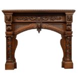 An imposing and richly carved oak Renaissance style fireplace mantle, decorated with scrollwork, lio