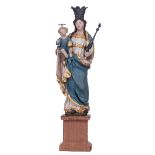 A gilt and polychrome painted wooden Madonna holding the Holy Child, with silver crowns and scepter,