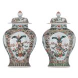 A pair of Chinese famille verte baluster vases and covers, decorated with flower sprays and butterfl