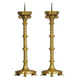 A pair of brass spindle-shaped Gothic Revival candlesticks, on three lion-shaped feet, H 80 cm