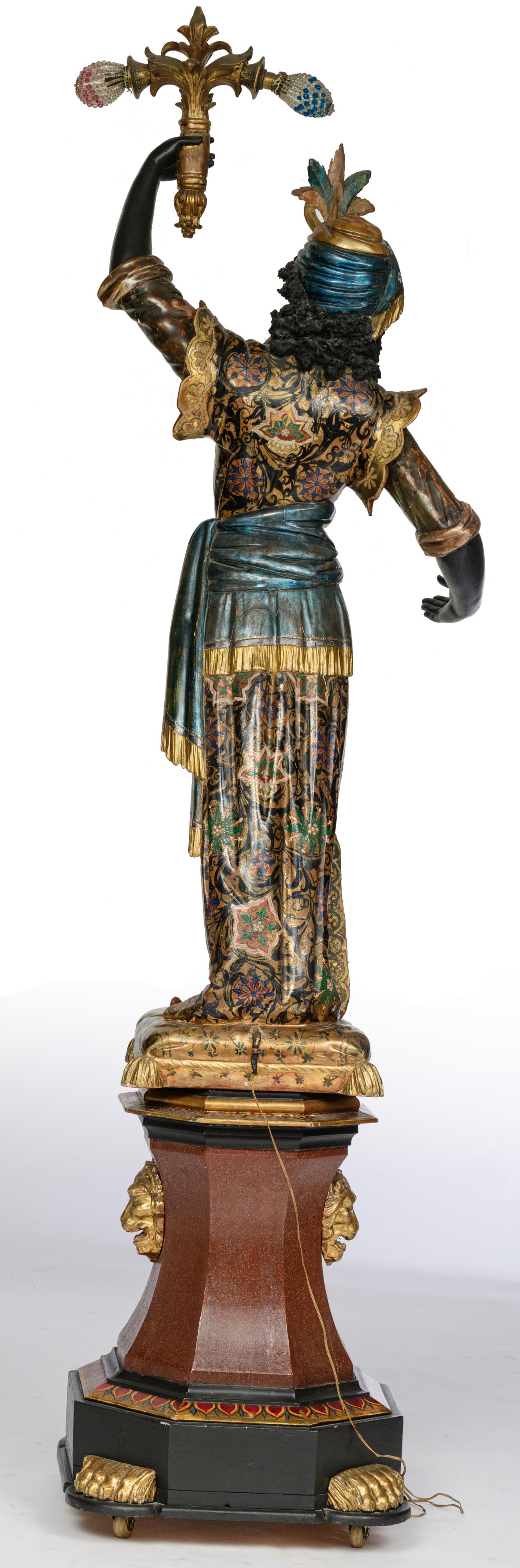 A Venetian polychrome painted and gilt wooden blackamoor torchŠre figure, dressed in an elaborately - Image 3 of 6