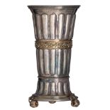 A silver parcel-gilt beaker, on a detachable base resting on three pomegranate feet with tendril spr