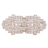 An 18ct white gold Art Deco style brooch set central with three bigger brilliant-cut diamonds and fu