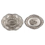 Two silver chargers with ornate repousse pierced work, one with the well depicting playing angels, t