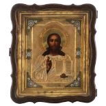 An Eastern European icon representing Christ with a gilt silver oklad and partially enamelled frame,