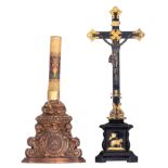 A richly carved walnut Baroque candleholder, decorated with S-volutes, angels, a cartouche and the s
