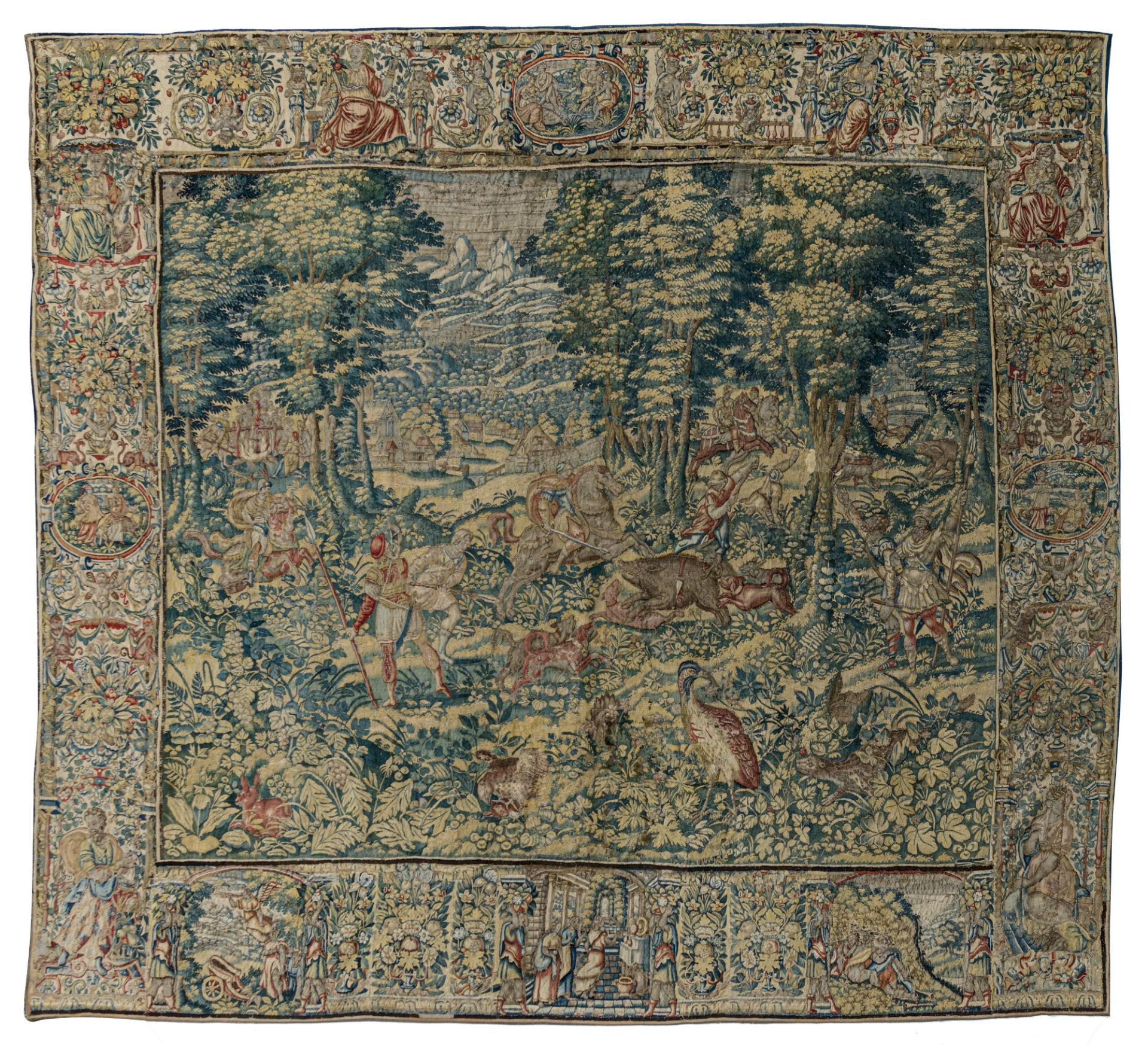 A Flemish wall tapestry, depicting wild boar hunting scenes, the border richly decorated with variou