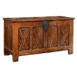 A large oak monastery chest with a wrought iron lock, the front decorated with X-panels, the Souther