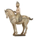 A cold painted Tang-type earthenware Ferghana horse with a foreign rider, H 42 cm