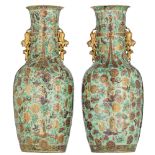 A pair of Chinese Canton famille rose on celadon ground vases, all over decorated with the Eight Imm