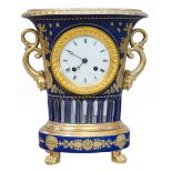 An Empire period bleu royal ground porcelain urn-shaped mantle clock, by the manufactory of Darte Fr