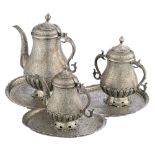 A Persian inspired horror vacui decorated tea set, no visible hallmarks but tested on silver purity,