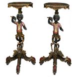A pair of black lacquered and polychrome painted occasional tables, shaped like two blackamoor figur