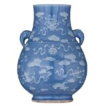 A Chinese pale blue glazed hu vase with slip decoration, paired with elephant head handles, 19thC, H