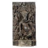 A large alto-relievo stone sculpture of the Hindu deity Ganesha, H 90,5 - W 48,5 cm