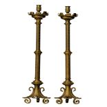 A pair of Gothic Revival brass church candlesticks, H 81 cm