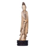 A Chinese finely carved ivory female Immortal, set on a cloud-sculpted hard wooden base, 19thC - Qin