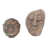 Two carved stone masks, largest mask 23 x 15 cm