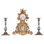 A Neoclassical gilt bronze mantle clock and two matching candlesticks with Sèvres type plaques, H 21