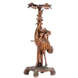 A Rococo style richly carved 'Grotto' stand of an ostrich with a cupid and a cherub on his back, H 1