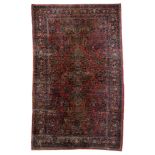 A large Oriental floral decorated woollen rug, 306 x 511 cm