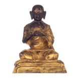 A Chinese gilt-bronze figure of a seated lama, H 15 cm