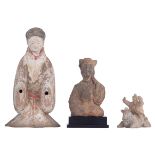 A collection of Chinese Tang style cold painted pottery fat ladies and a figure on a horse, tallest