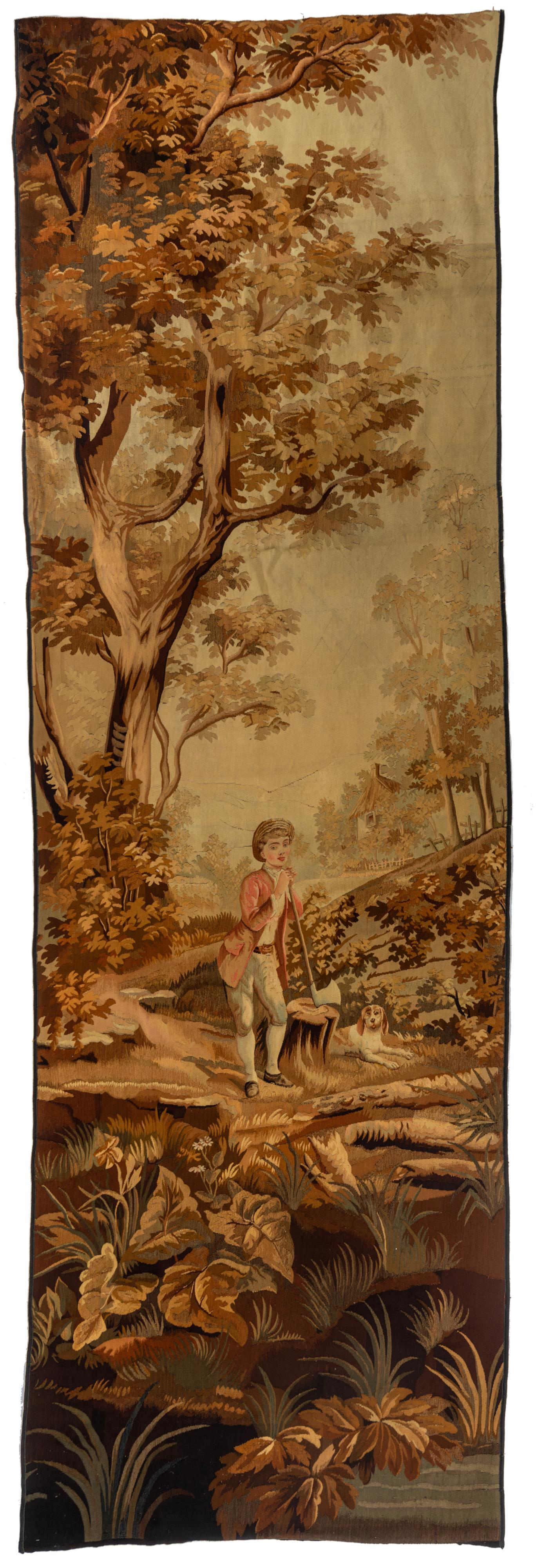 An Aubusson type tapestry, decorated with a lumberjack scene, 19thC, 125 x 405 cm