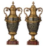 A pair of Neoclassical bronze vases, decorated with a basso-relievo frieze of a bacchanal, H 44 cm