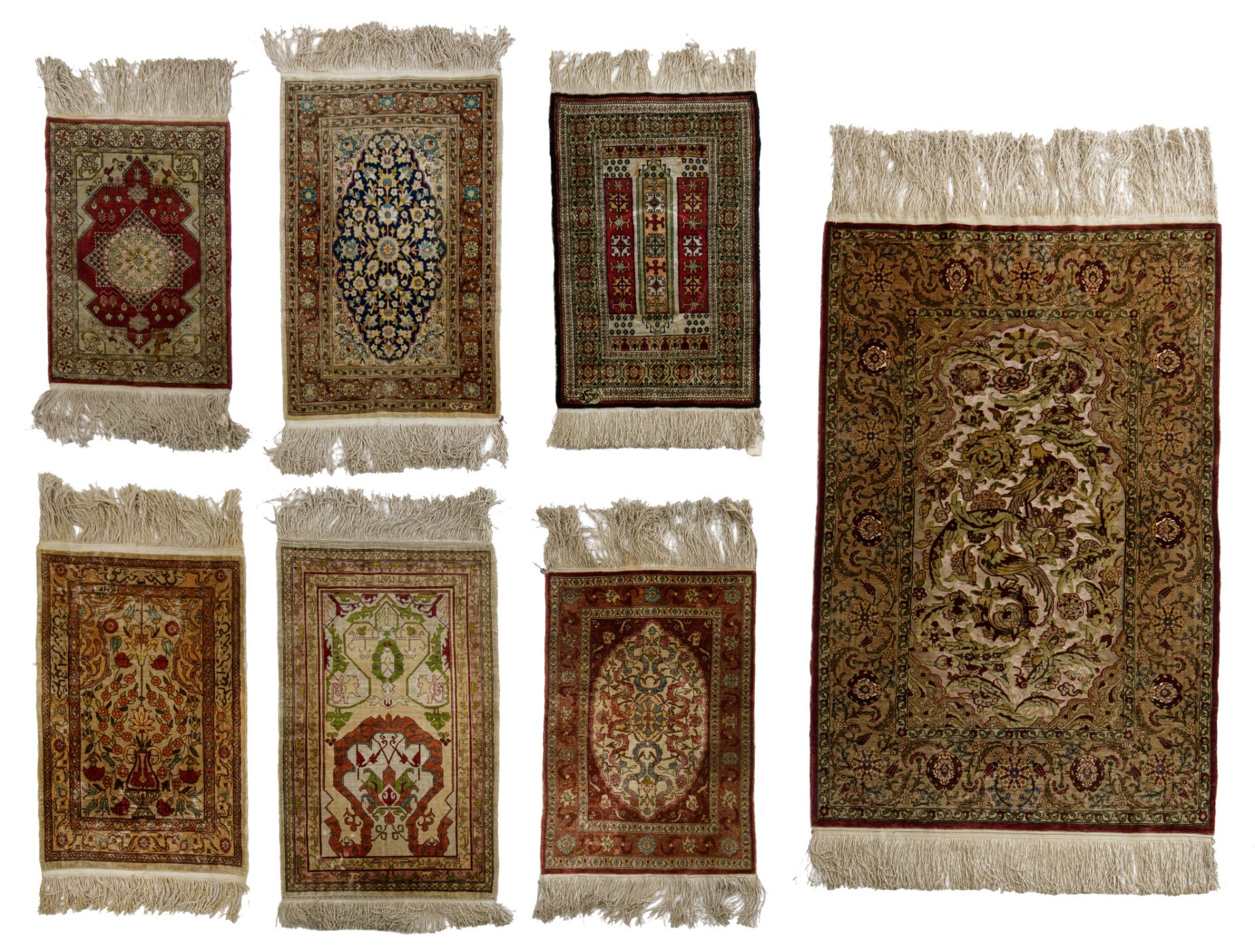 A collection of seven Oriental silk carpets, of various dimensions