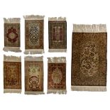 A collection of seven Oriental silk carpets, of various dimensions