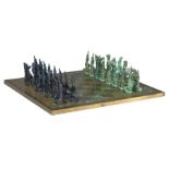 A Giacometti inspired bronze chess set, 40 x 40 cm