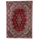 A large Oriental woollen rug, floral decorated, signed, 360 x 260 cm