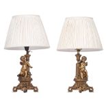 A pair of Napoleon III gilt bronze table lamps, decorated with Amor figures, H 38 - 67 cm