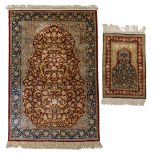 A silk Hereke rug, signed; added a ditto smaller rug, 124 x 197,5 / 61 x 88,5 cm