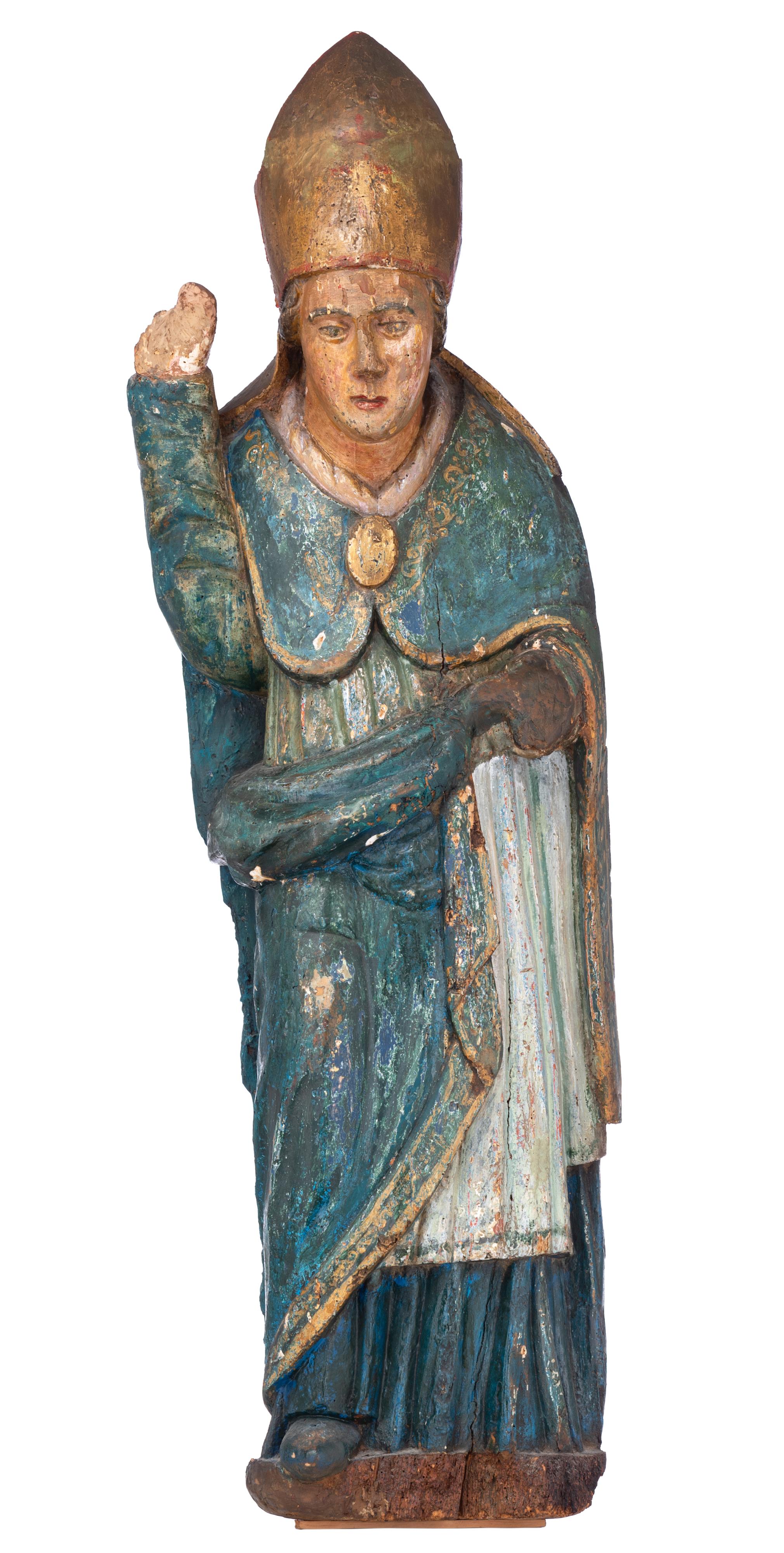 A walnut sculpture of a standing bishop, 15thC or later, H 124 cm