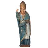 A walnut sculpture of a standing bishop, 15thC or later, H 124 cm