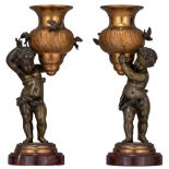 A pair of bronze putti carrying an urn-shaped vase, H 25 - 27 cm