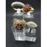 Four gold rings, a 9ct gold and 20 red stone ring with decorated shoulders, 47 gms size N, a white