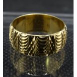 Gold Ring - a heavily patterned 9ct wedding ? band weighing 81.5 gms dating to 1998, maker LDP ,