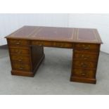 Partners Desk - a 20th C mahogany pedestal desk with gold tooled red leather inserts to top, with