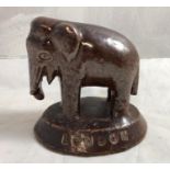 Promotional / Advertising paperweight , an early 20 th C brown glased earthenware figure of an