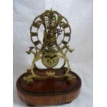 Skeleton clock ( Timepiece) : a chain fusee movement within a shaped brass frame on an oval rosewood